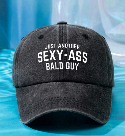 A gray baseball cap with the text 'JUST ANOTHER SEXY-ASS BALD GUY' printed on the front.